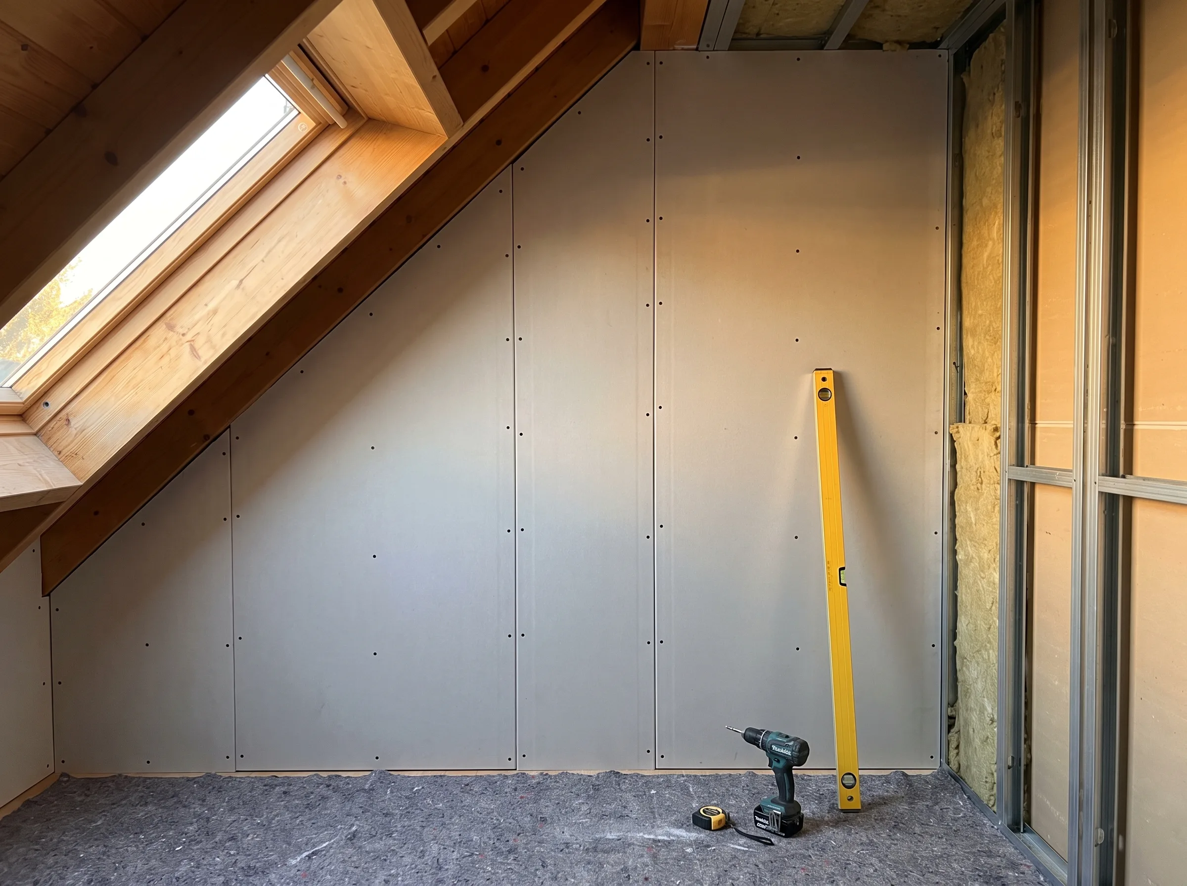 Trockenbau mit Gipskartonplatten und einem Fenster in einem Dachraum